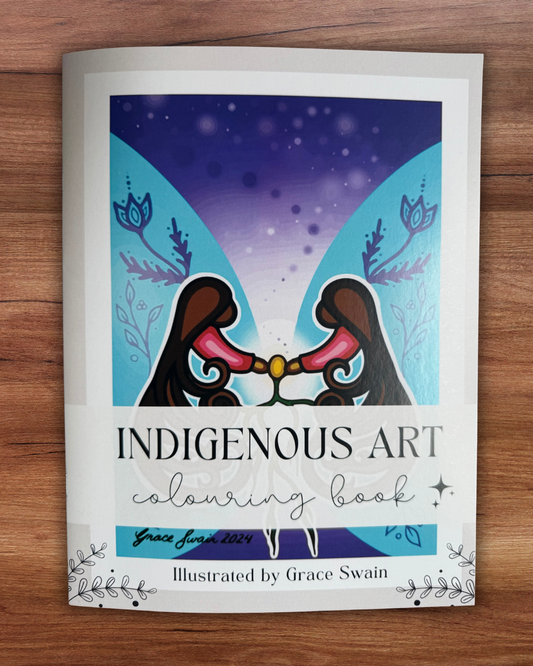 Indigenous Art coloring book on a wooden surface